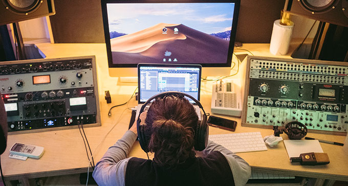 a woman using the facilities in the recording studio at Root Seventy Three