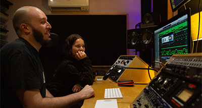 two people working together in a one-to-one mixing and mastering session