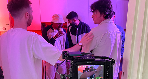 a group of people about to record content for a music video