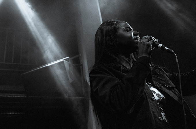 a woman on stage singing as a concert